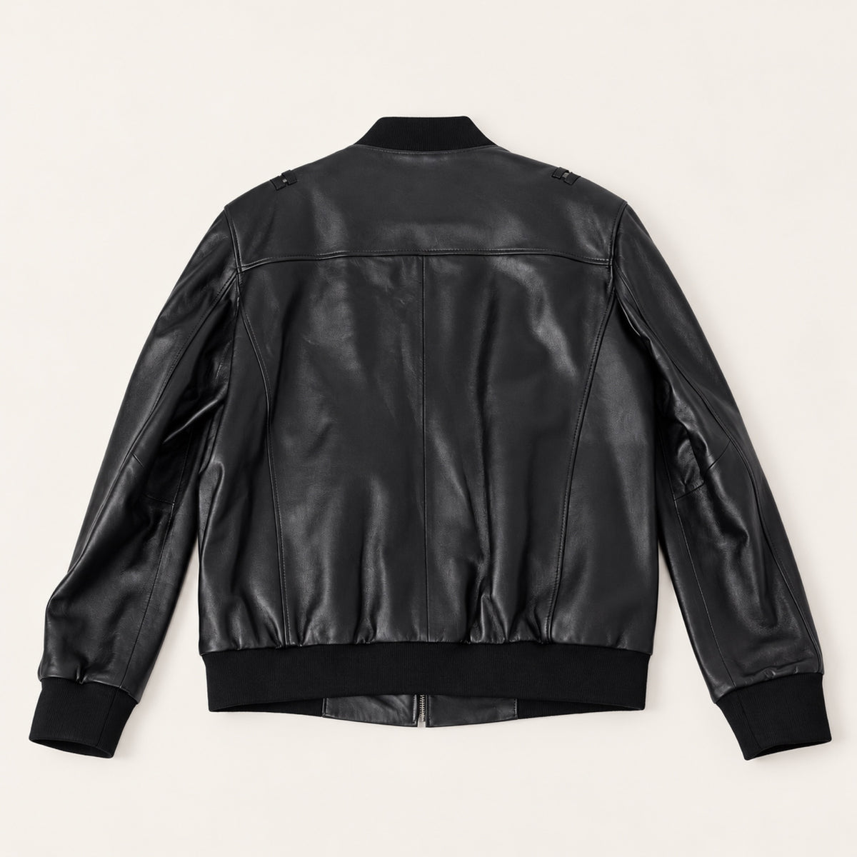 Black Bomber Jacket, rear view on an ivory studio background.