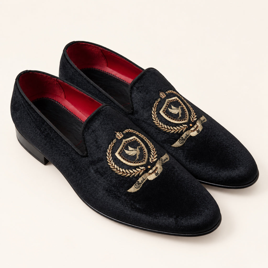 The Sultan Embroidered Loafer — Black, three-quarter front view on an ivory studio background.