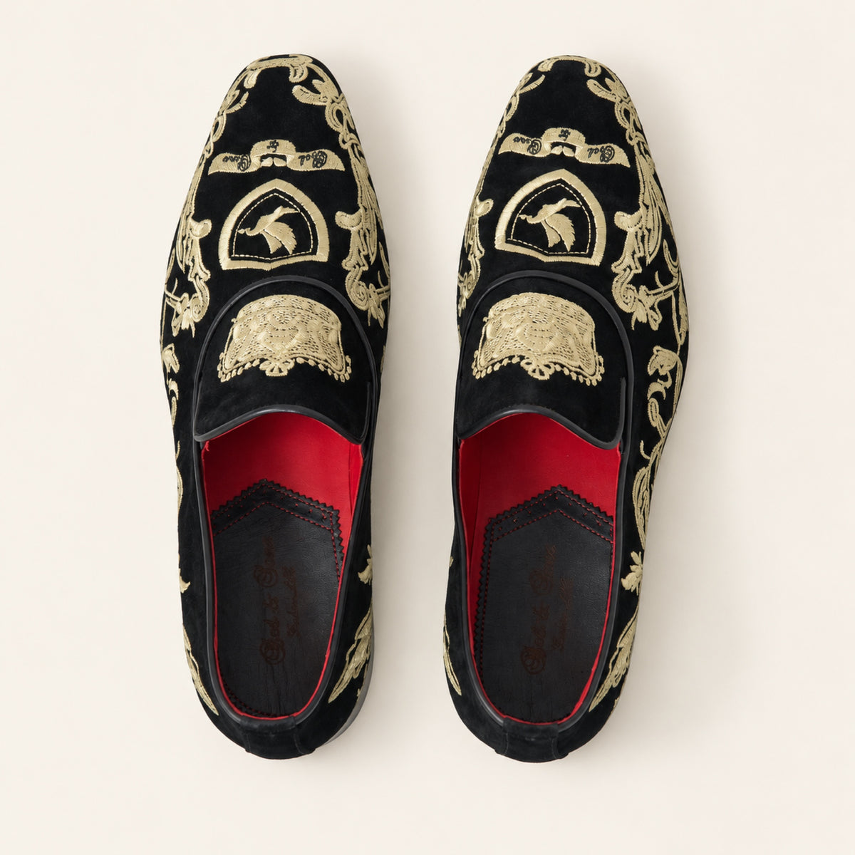 The Sultan Embroidered Loafer — Black & Gold, top view on an ivory studio background.